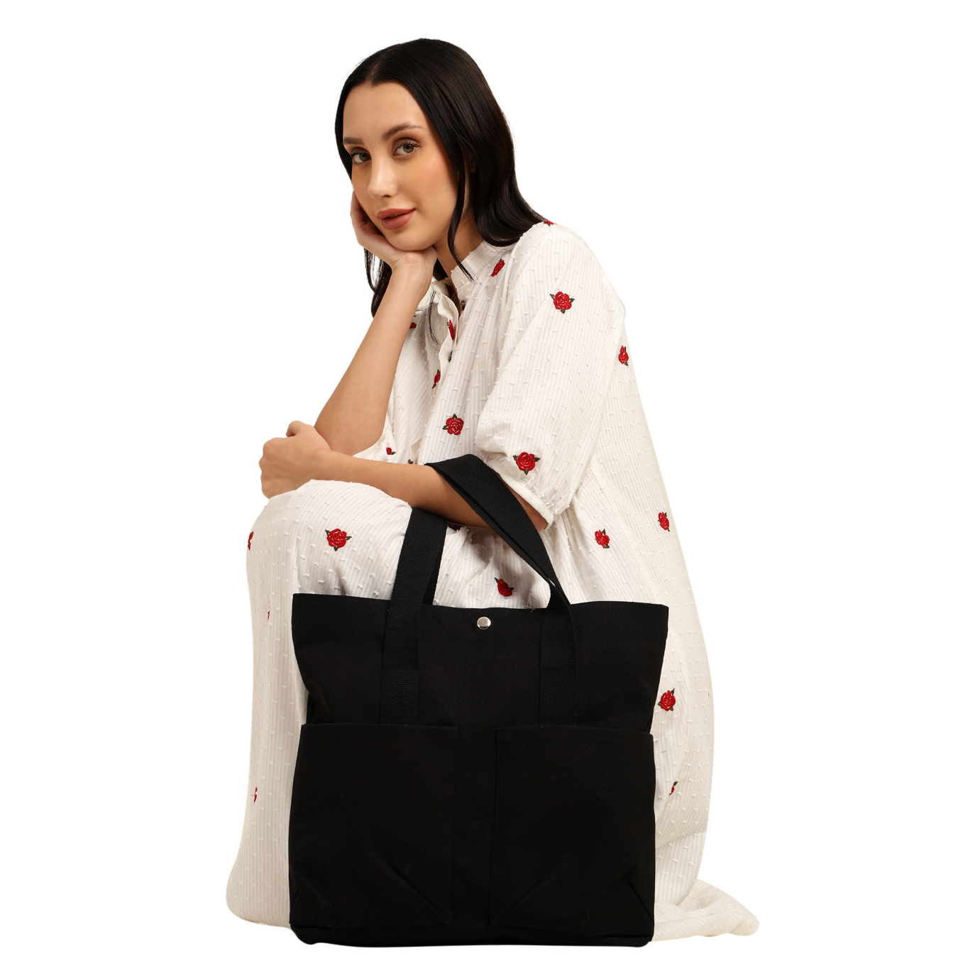 Woman holding a black tote bag against a white background PT-TRO-BLK