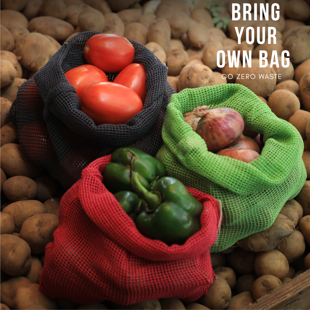 Reusable mesh bags with vegetables on a bed of potatoes, promoting zero waste. PT-MSH-NGR