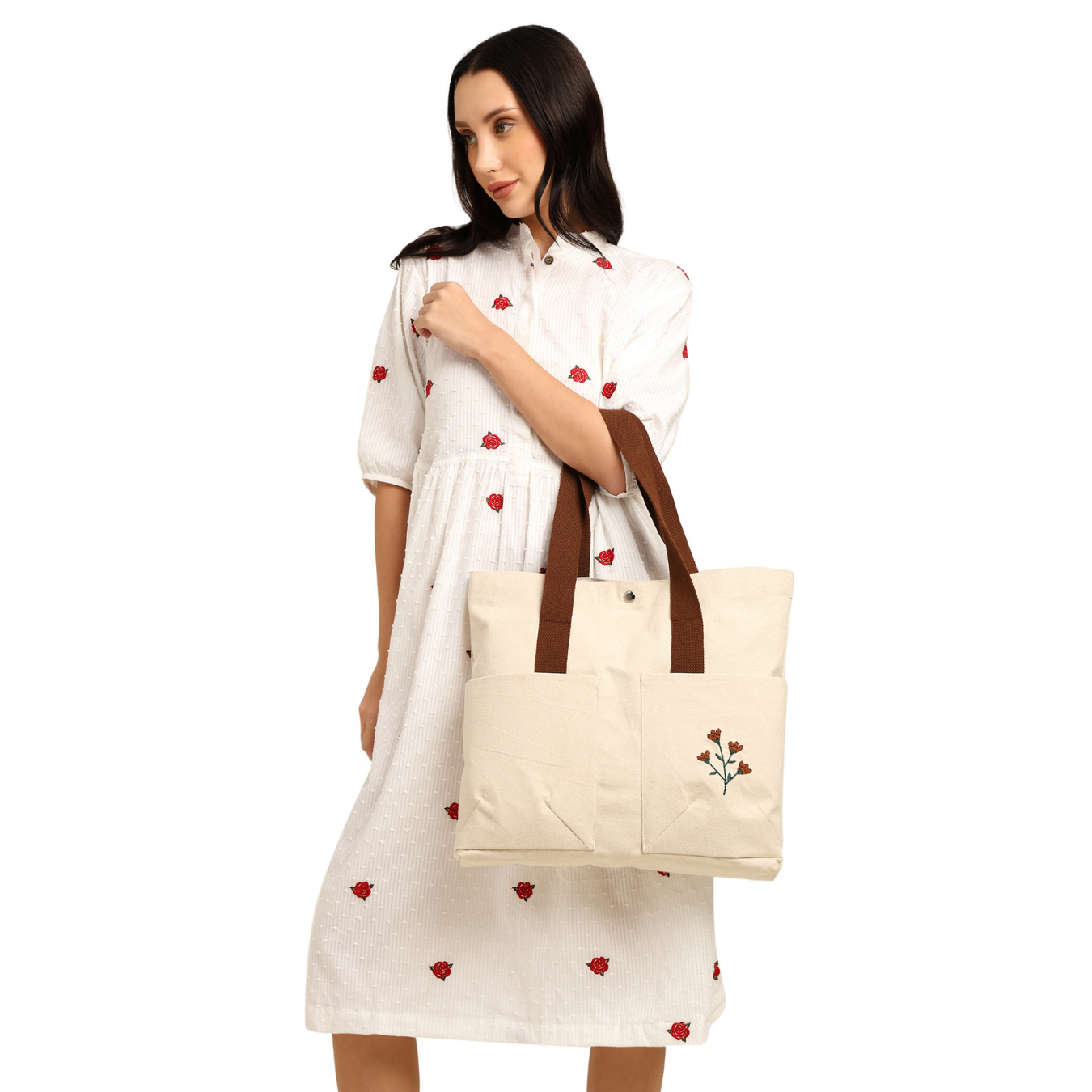 Woman holding a beige tote bag with brown handles on a white background PT-TRO-BRW