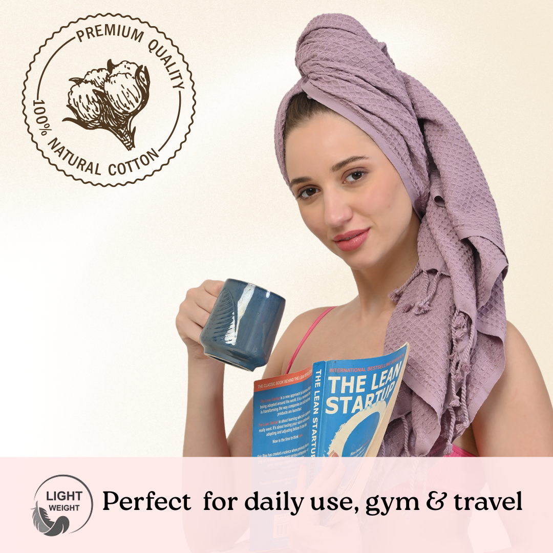 Woman with a lilac waffle towel on her head holding a mug and a book, with a premium quality label and text about the towel's uses.(PT-WFL-LAC)