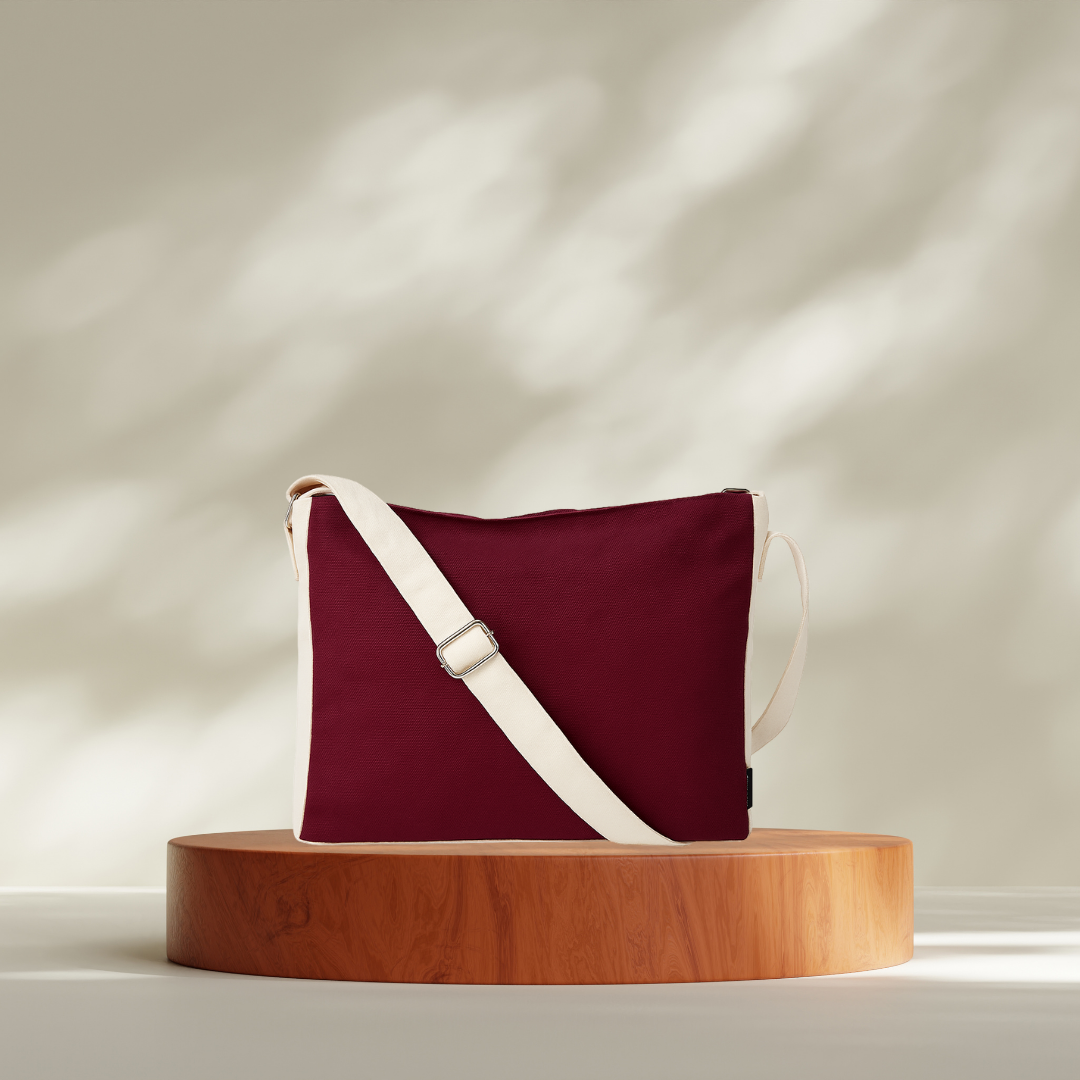Maroon handbag with a white strap on a wooden stand against a neutral background NC-DMC-MRN