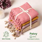 Stack of Brick, yellow, lilac and beige textured towels with tassels on a light background, featuring Patvy branding.(SKU:[PT-WFL-YLW PT-WFL-LAC PT-WFL-BRK  PT-WFL-BIS]