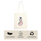 Tote bag with a hand gesture design and sustainability icons on a white background