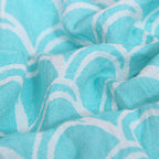 Close-up of turquoise fabric with white geometric pattern VU-OCN-SEA