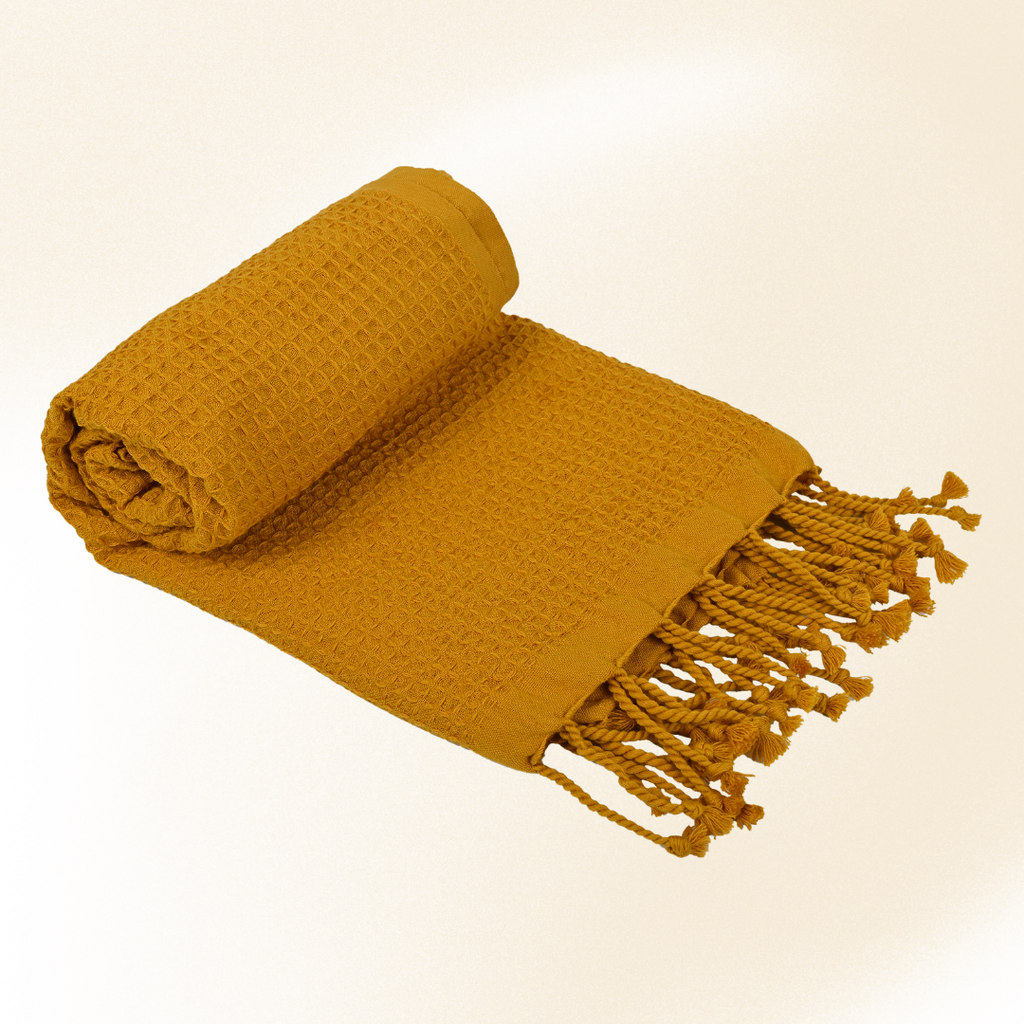 Mustard yellow waffle towel on a beige background (PT-WFL-YLW )