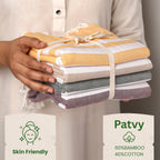 Stack of folded towels held by a person with 'Patvy' branding and product details.(PT-BMB-MST PT-BMB-BRG PT-BMB-TPE PT-BMB-EMR)