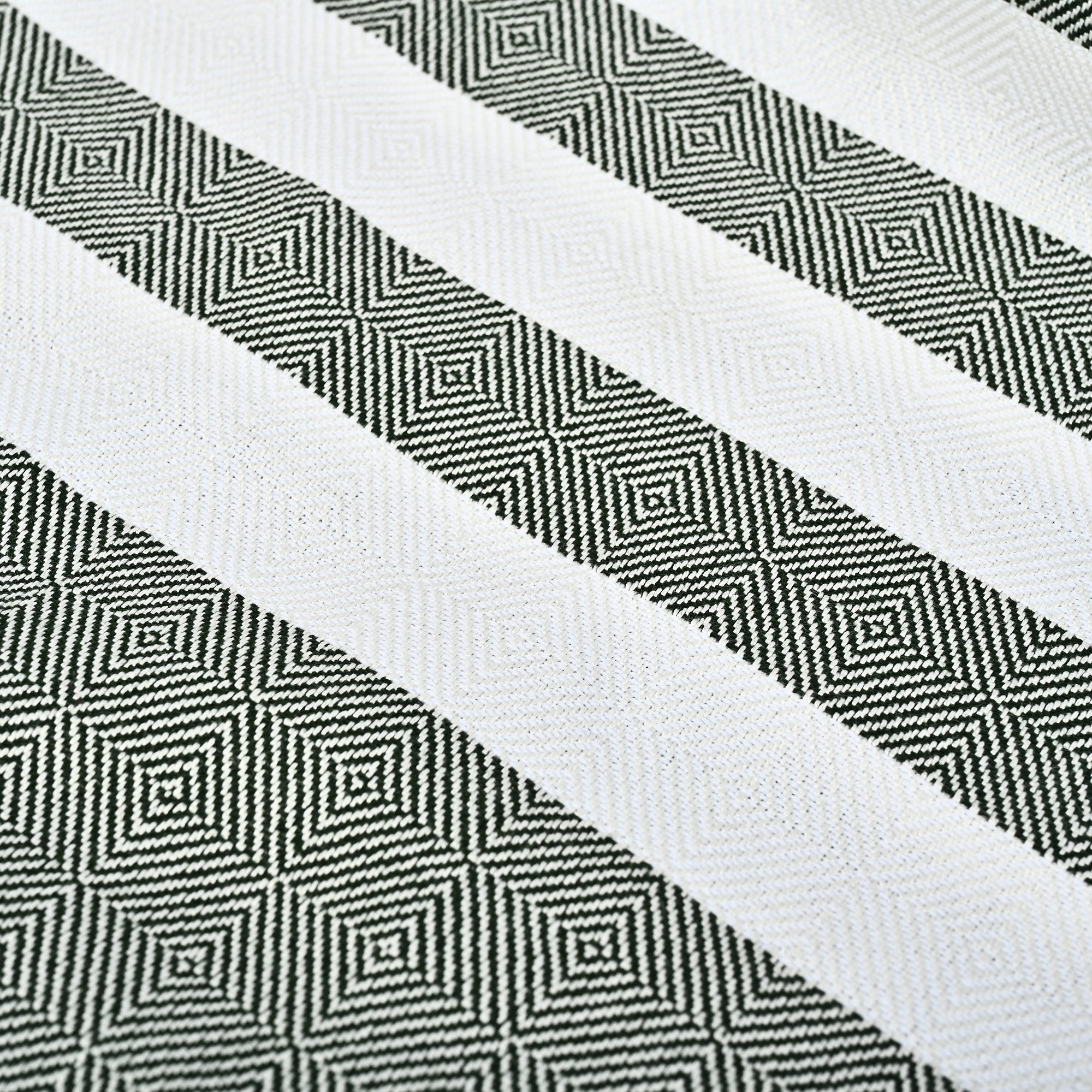 Close-up of a woven fabric with emarld and white geometric pattern(PT-BMB-EMR)