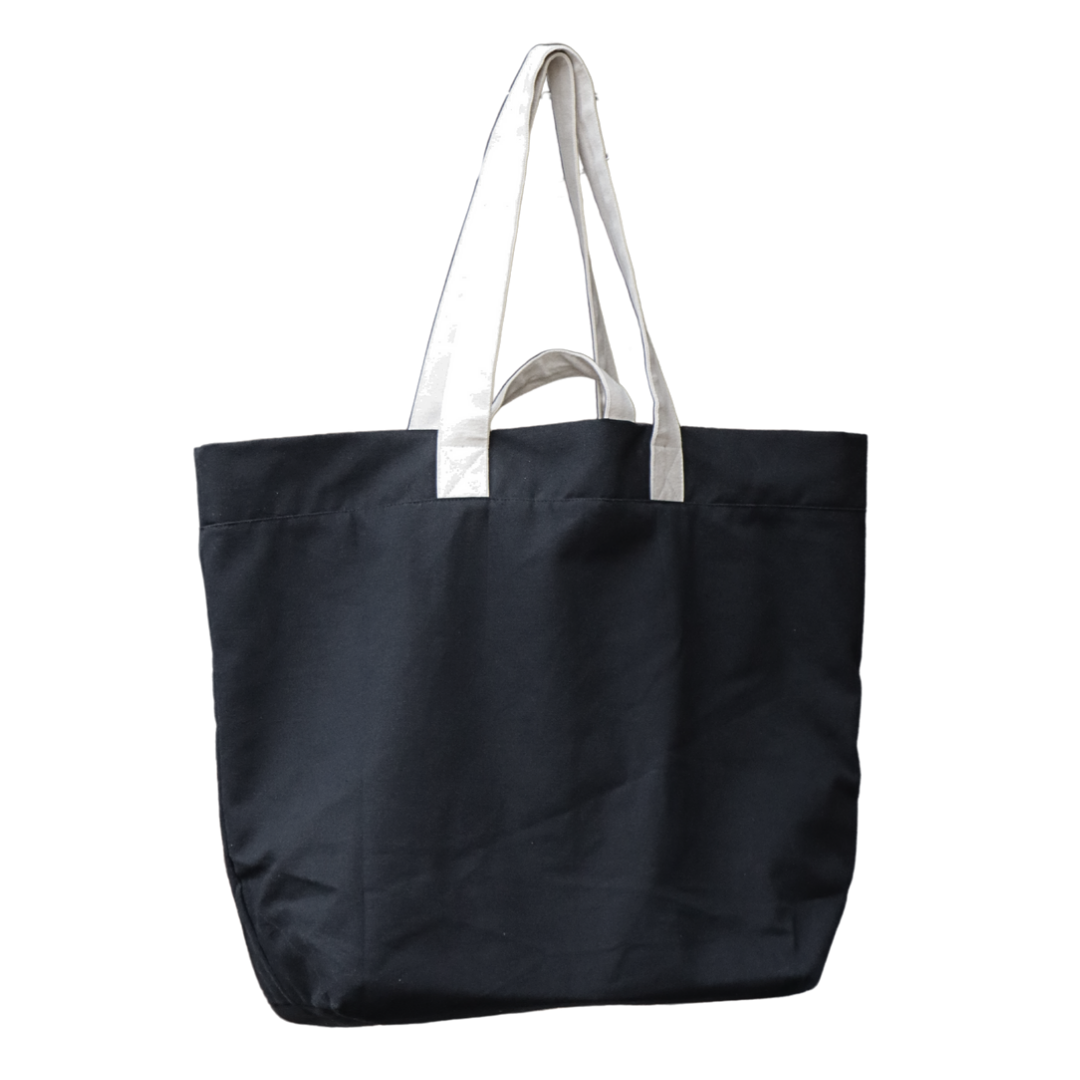 This image displays a collection of jumbo multi-purpose bags, available in a variety of colors including green, pink, black, and white. Each bag features a spacious design with durable handles, suitable for a variety of uses. [NC-JMB-BLK]